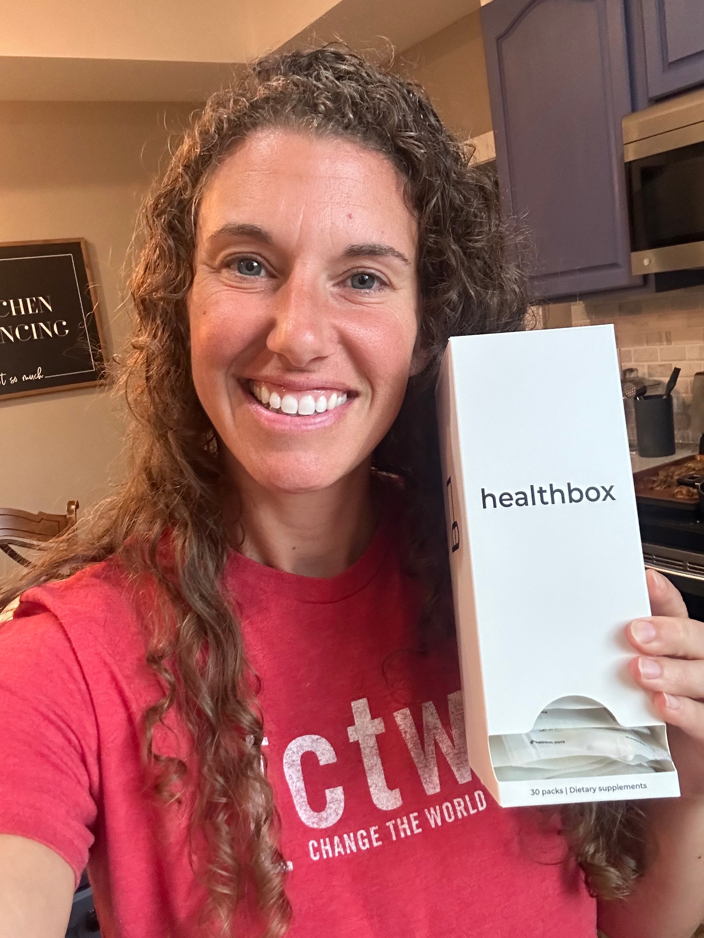 Person holding a Healthbox product box with a smile
