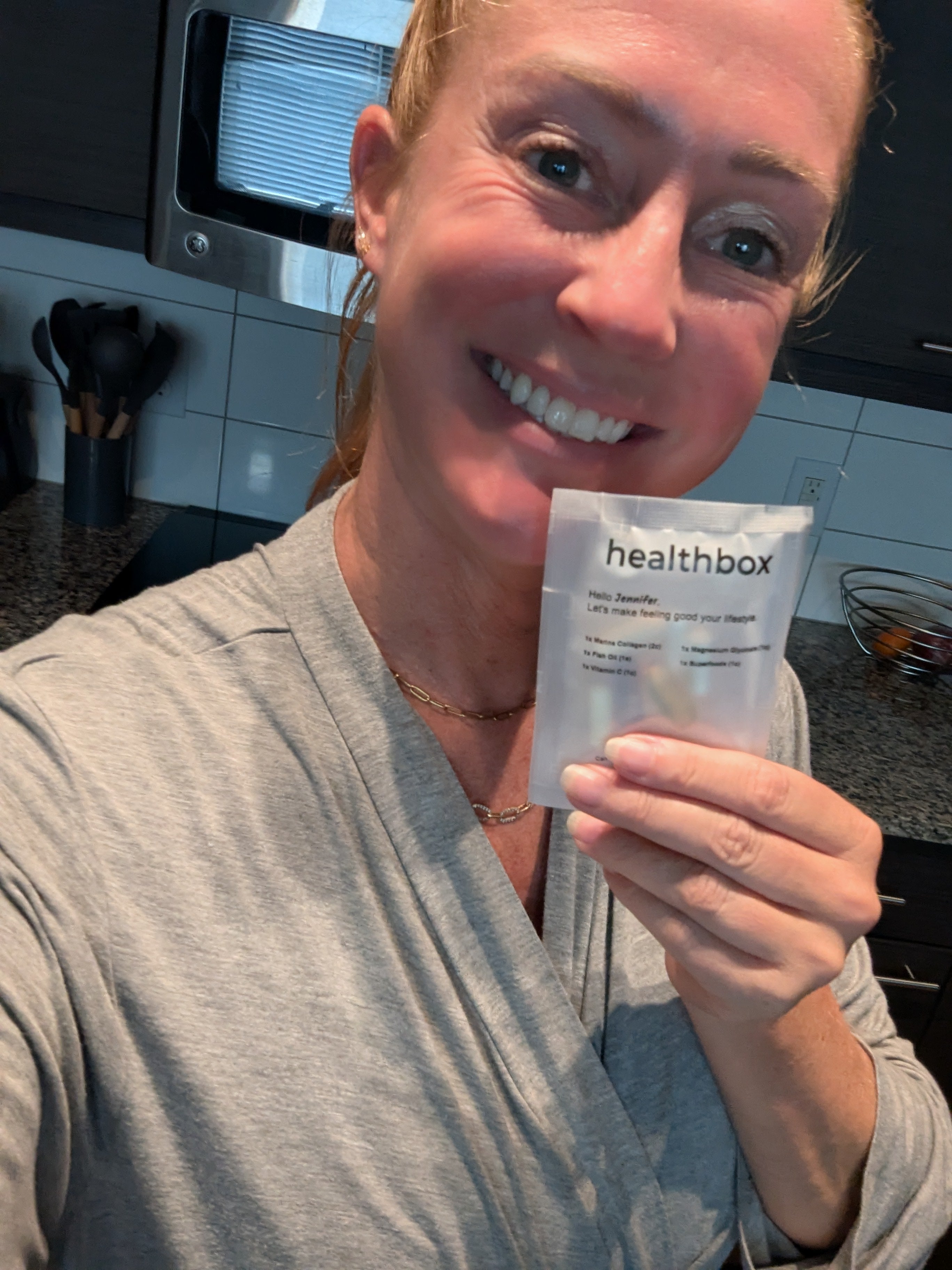 Person holding a Healthbox  product in a kitchen setting