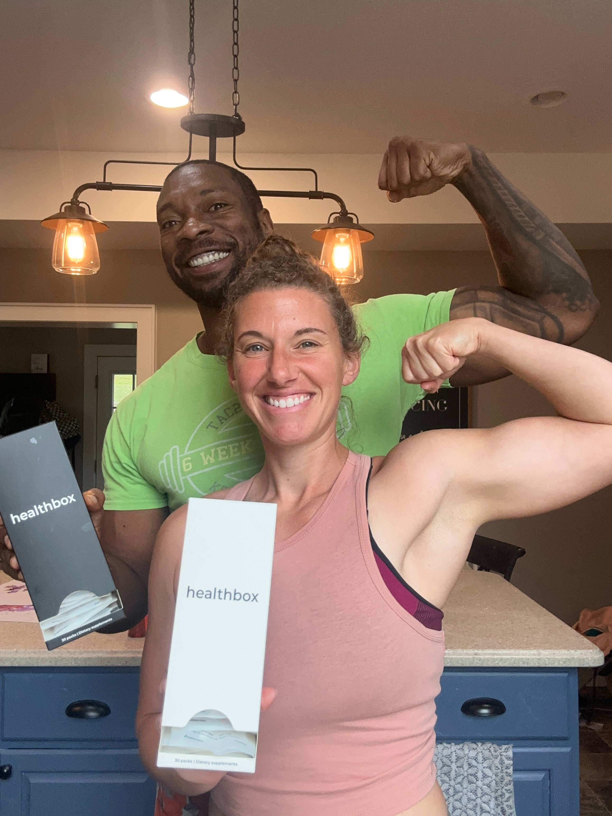 Two people holding a Healthbox product in a casual indoor setting
