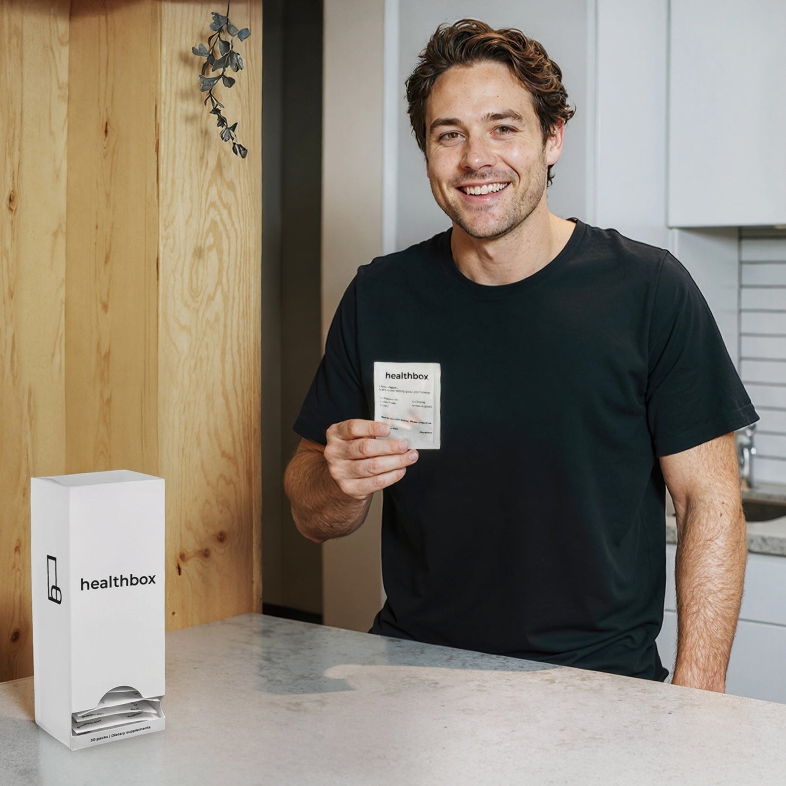 Vitamin E 400 IU daily sachet by Healthbox personalized vitamins in a white dispenser with a smiling man